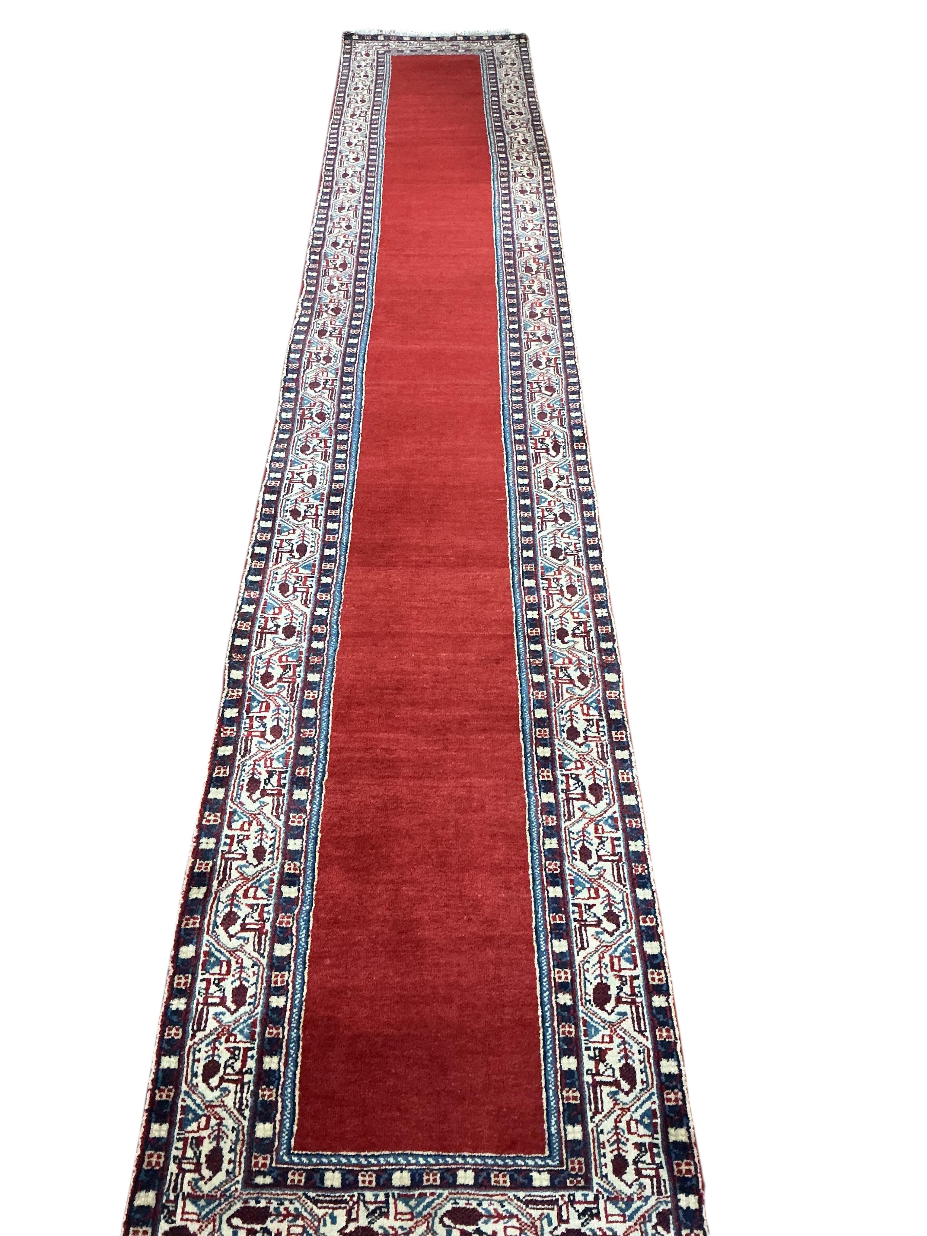 An Araak red ground runner, 440 x 76cm